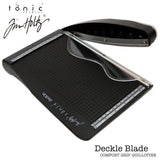Tim Holtz Deckle (Torn Edge) Blade Guillotine Paper Cutter - with a unique torn edge style blade, ergonomic comfort Kushgrip handle. Use to create the look of rugged torn edges to paper and cardboard easily and quickly. Made by Tonic Studio with precision ground, ultra sharp blade with a rough ragged pattern, this strong trimmer is built to last. With its measurements on the baseboard in metric and imperial, this cutting tool is perfect to cut deckle or ragged edges to scrapbooking and cardmaking projects.